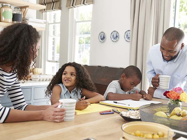 Family sitting together at the kitchen table.