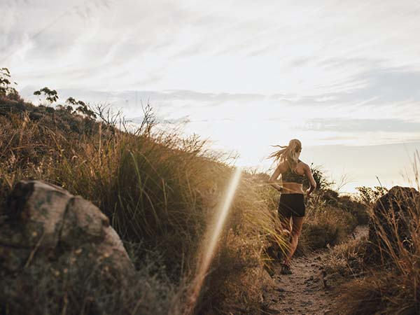 woman trail running in nature.