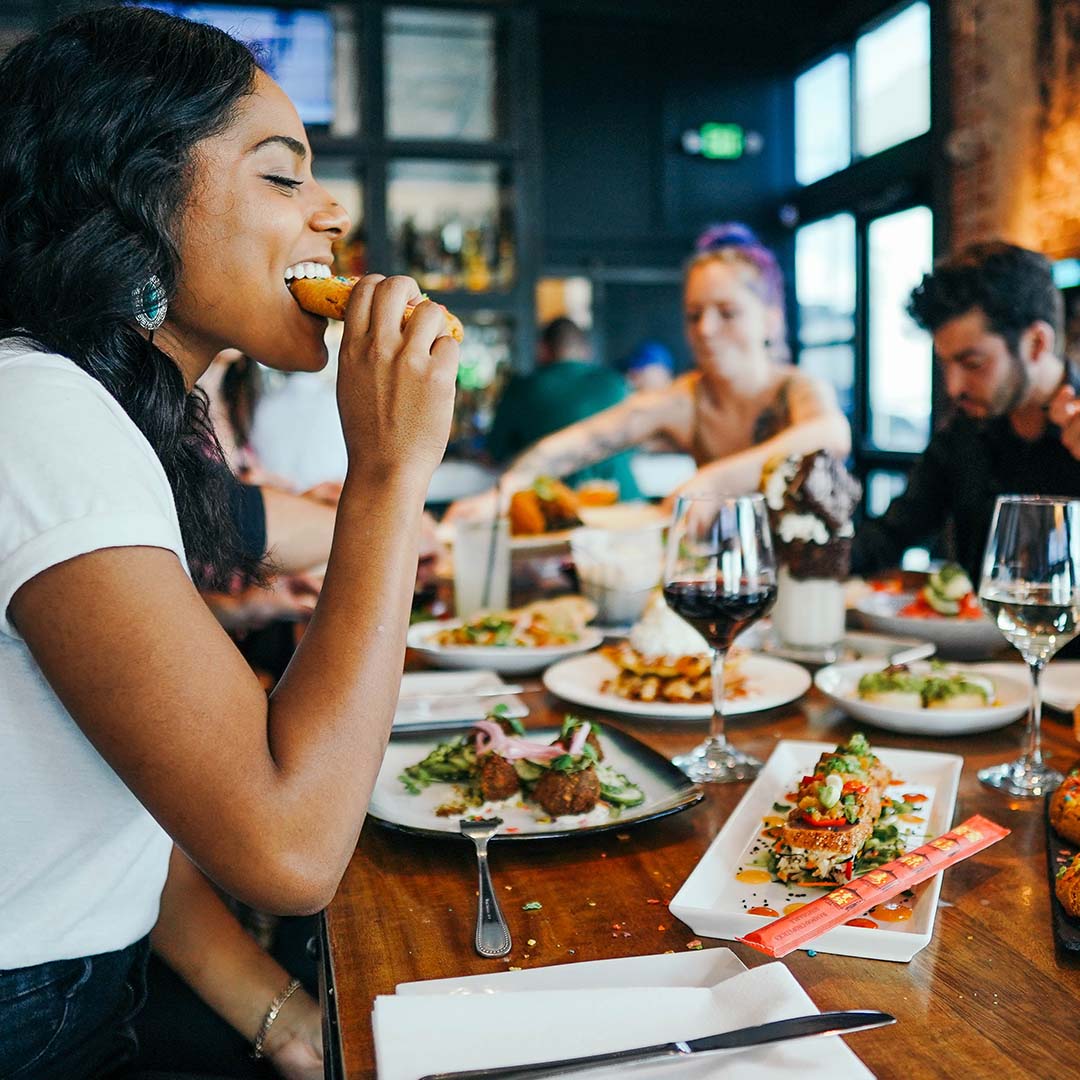 Woman enjoying small plates at a restaurant