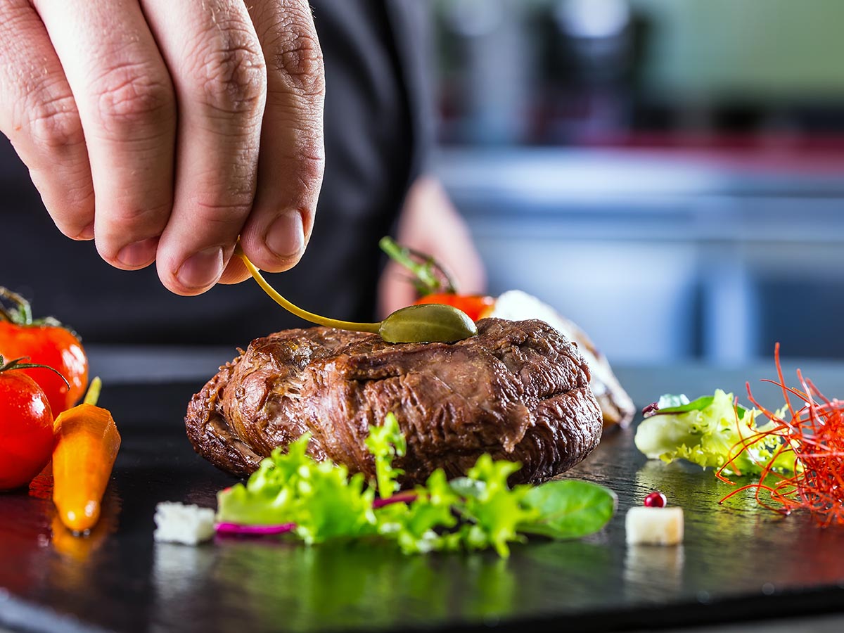 Chef preparing a steak meal