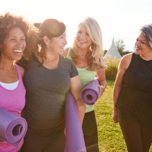 A bunch of women with yoga mats